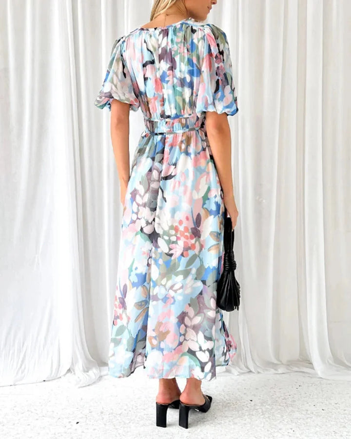 "Rhoda floral maxi dress featuring long sleeves, made of lightweight fabric with a vibrant floral pattern."