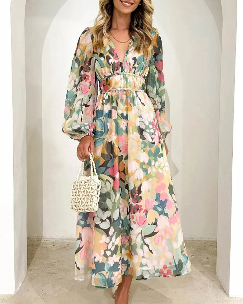 Floral maxi dress in soft, flowing fabric with elegant long sleeves perfect for day-to-night wear.