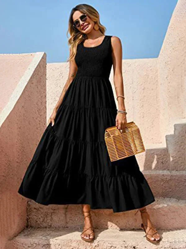 Black sleeveless maxi dress with a smocked bodice. Flowy and lightweight fabric with a subtle floral pattern. Perfect for…