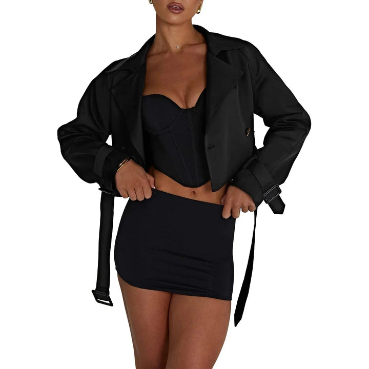 Black cropped trench coat in modern design by Malia. Made from durable and stylish material, perfect for a fashionable…