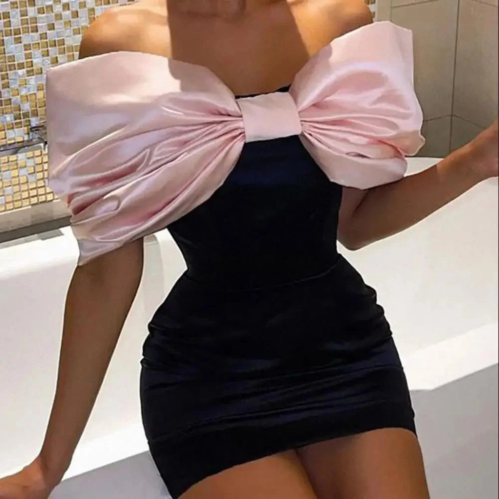 Off-shoulder dress in navy blue with a charming bow accent, perfect for a graceful and stylish look at your special events.