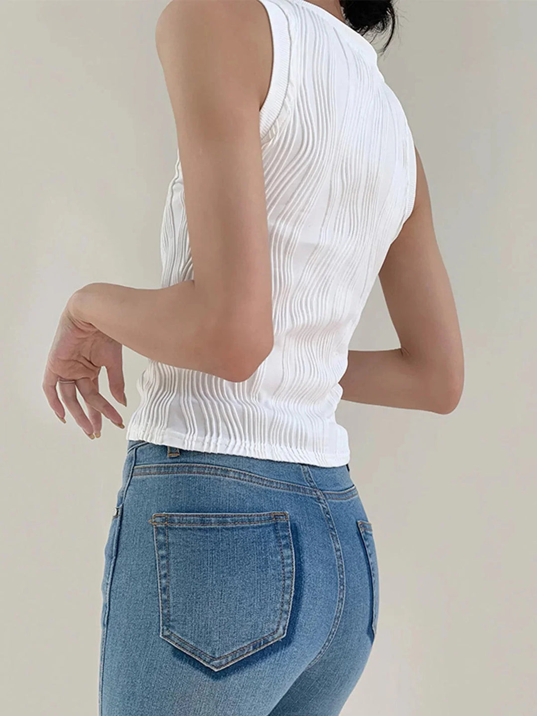 Sleeveless ribbed top in Elowyn featuring a smooth, fitted silhouette and a collarless design, ideal for effortlessly chic…