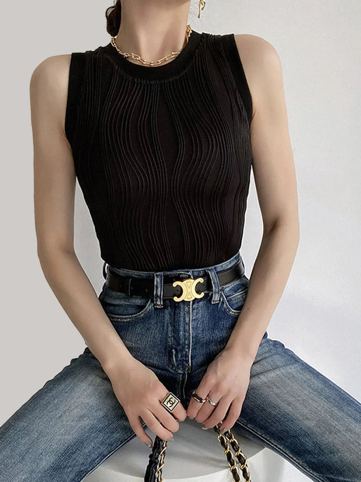 Black sleeveless ribbed top showcasing a sleek design and flattering fit. Made from a soft and stretchy fabric for all-day…