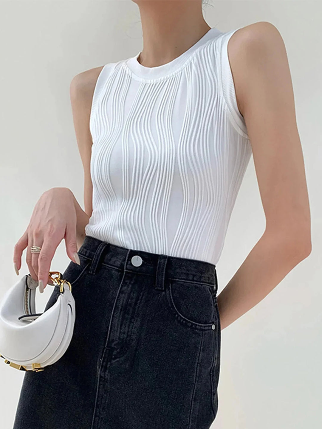 White ribbed sleeveless top, Elowyn brand. Sleek and modern design, perfect for layering. Made with soft and comfortable…