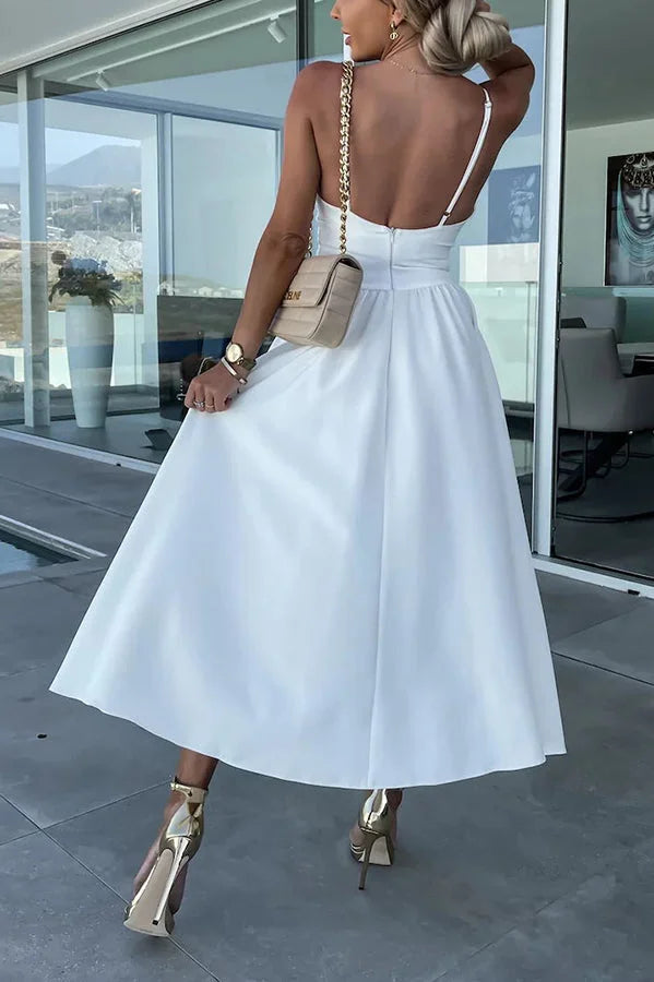Mayli dress featuring cut-out detail, pockets, and midi length in cotton blend fabric.