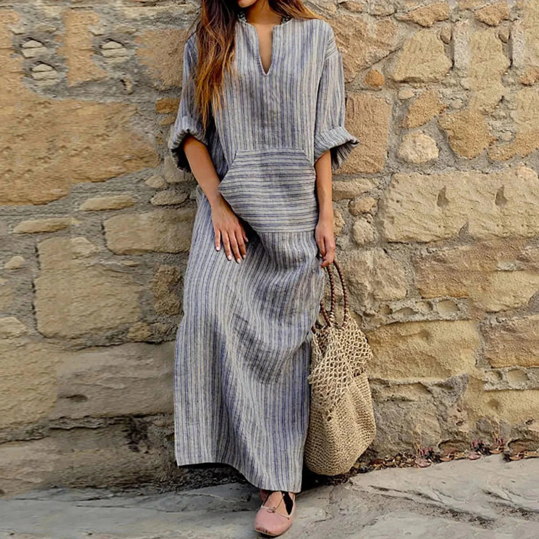 "Macy maxi dress in striped pattern with V-neck and convenient pockets, perfect for casual chic style."