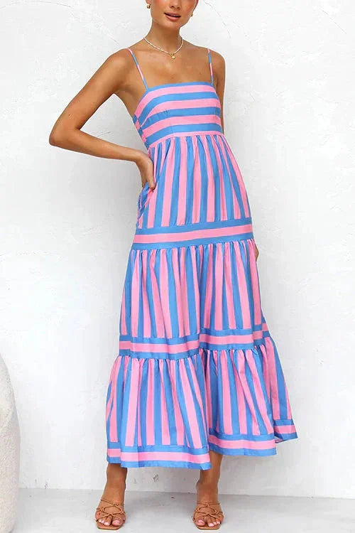 "Adaly tiered maxi dress in light beige, with strappy top, flowy silhouette, and intricate lace detailing."