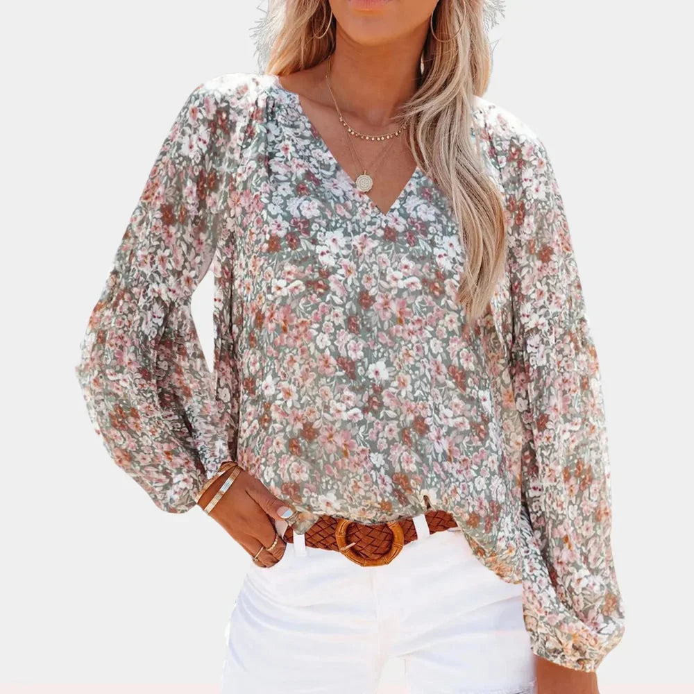 Multicolour Sheila blouse with V-neck, bell sleeves & intricate pattern. Made of lightweight, breathable fabric.