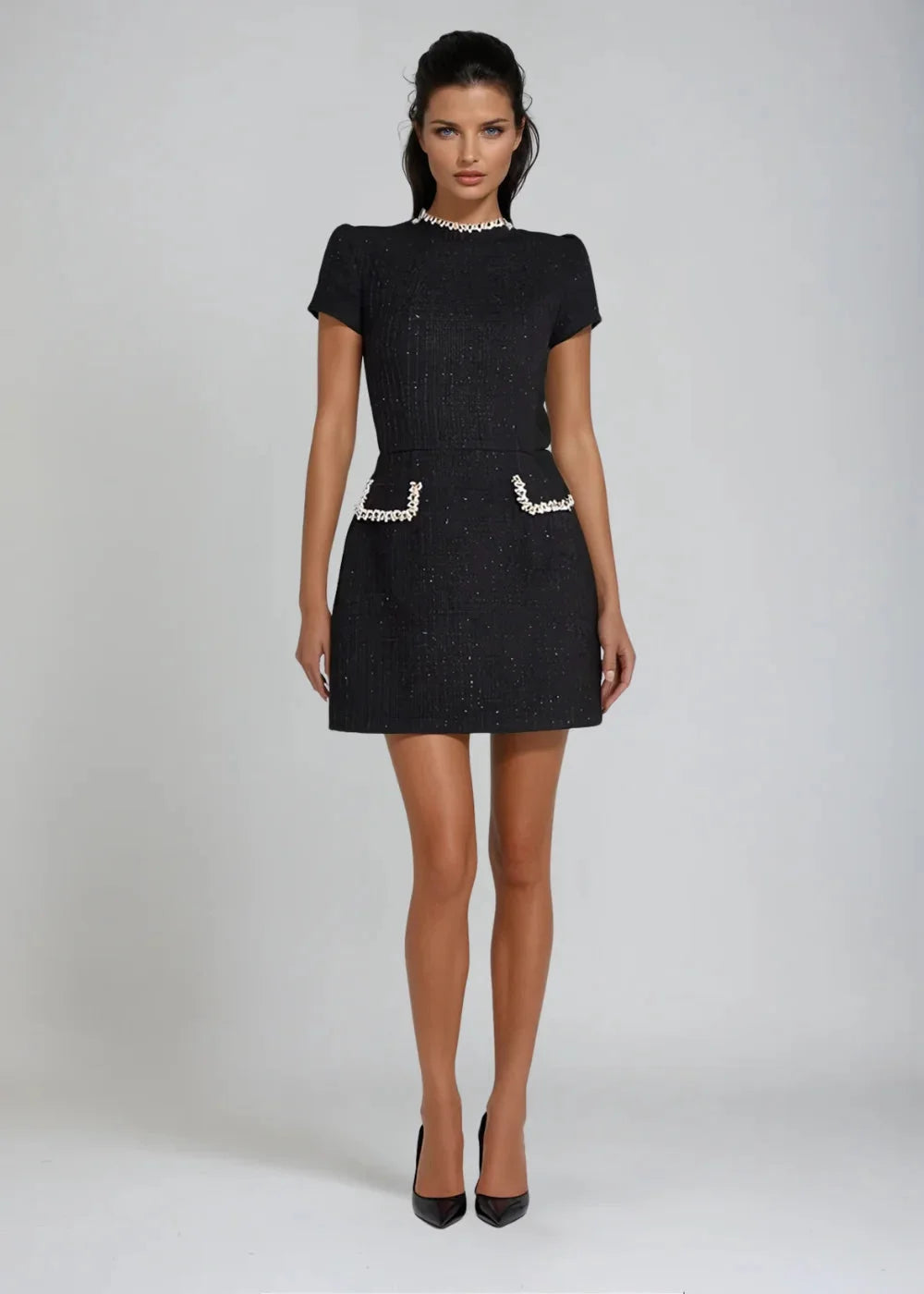 Kara mini dress features a mock neck design with intricate bead details, perfect for a chic and stylish look.