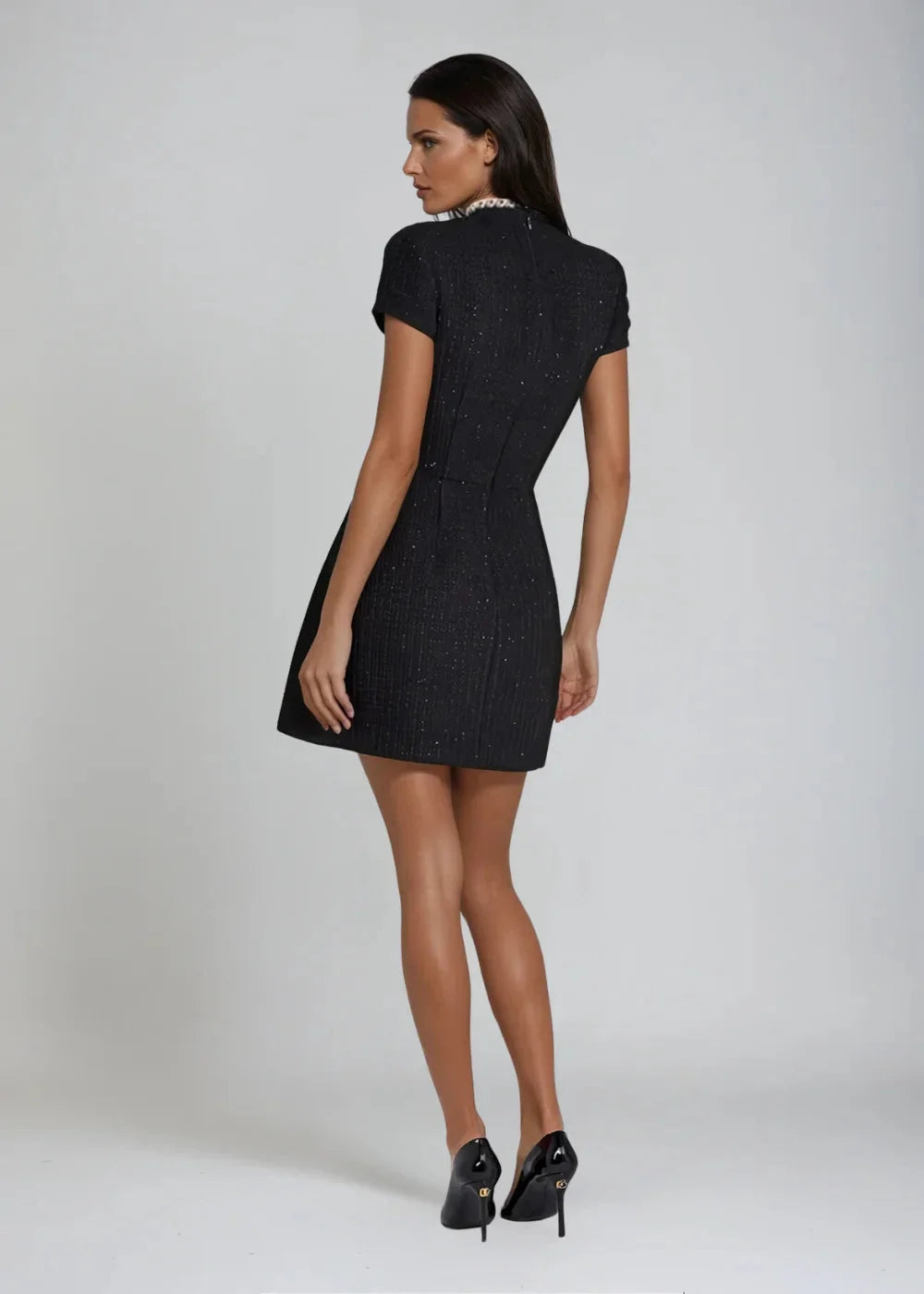 Kara Mini Dress: Sleeveless mock neck design with delicate bead details, perfect for any occasion.