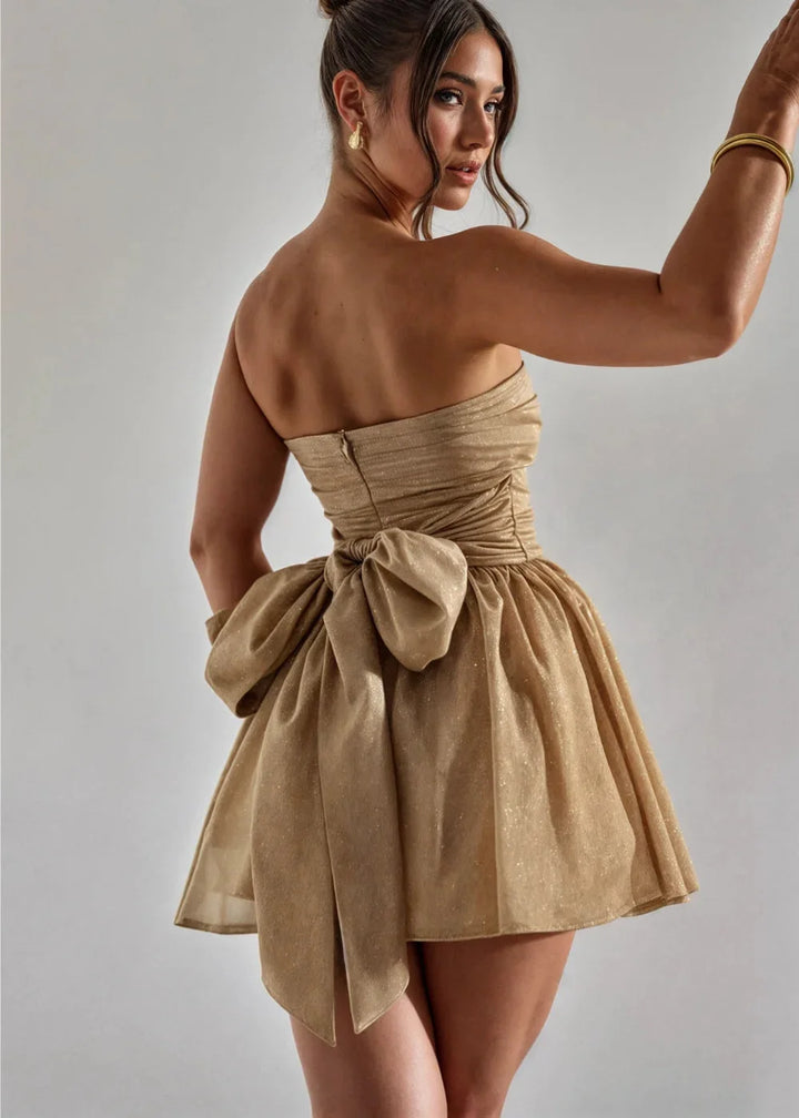 Strapless mini dress in Avelina yellow with elegant bow detail at the front. Ideal for summer outings and parties.