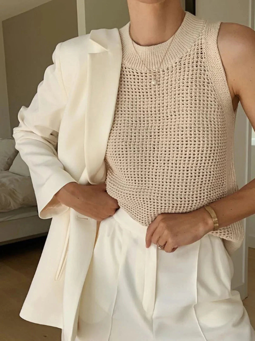 Sleeveless knit top featuring breathable fabric with a chic design.