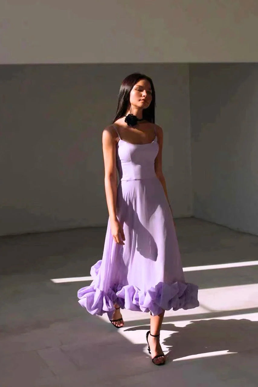 "Juana sleeveless dress in white with tiered ruffle hem, perfect for spring events."