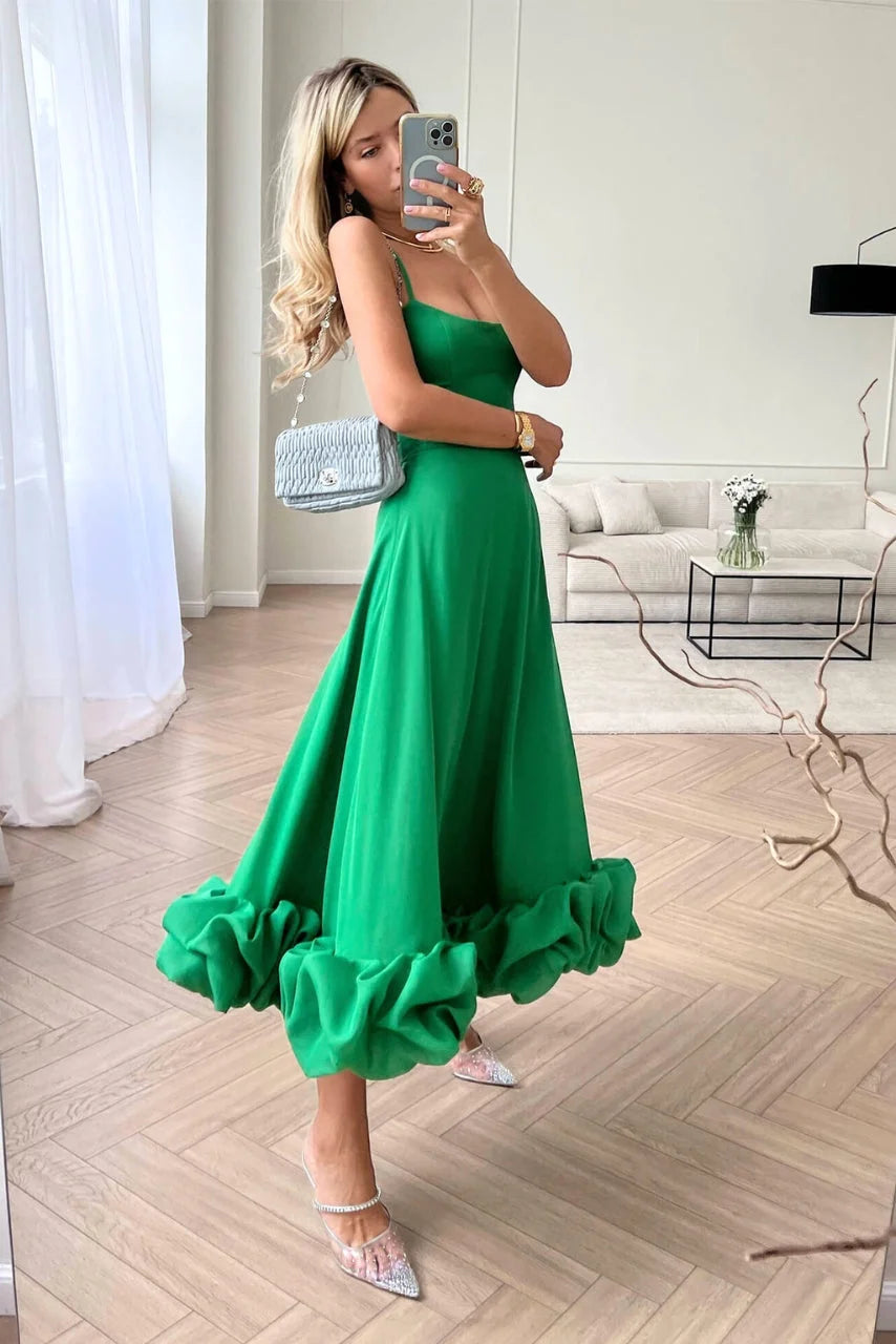 "Juana green sleeveless dress with ruffled hemline, made of lightweight fabric with a flattering A-line silhouette."