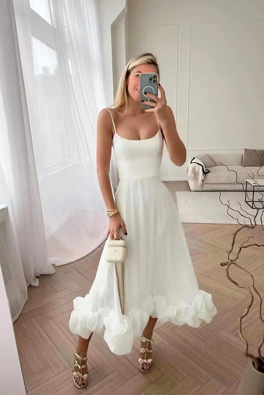 White sleeveless dress with ruffled hemline, made from soft cotton fabric. Flowy design perfect for a casual yet stylish…