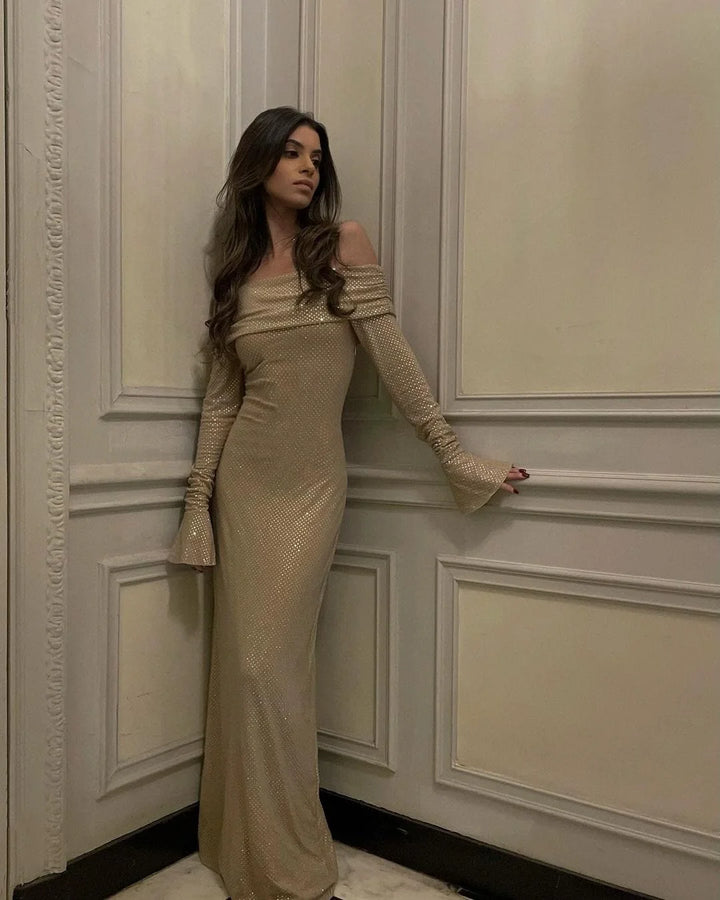 Shimmering long dress with elegant shoulder details, perfect for special occasions.