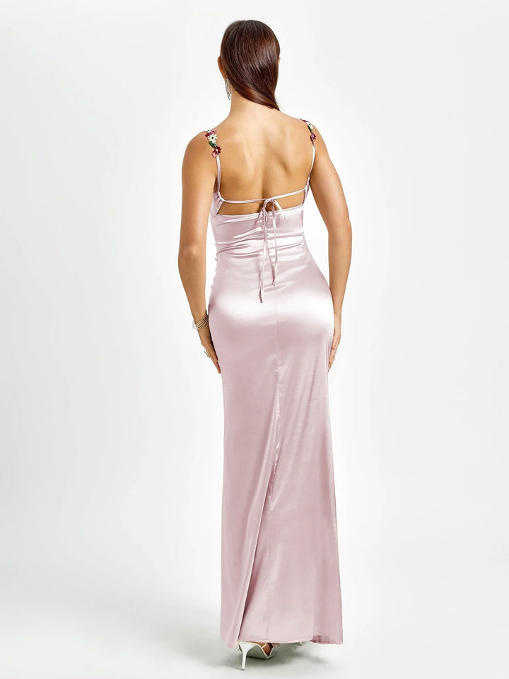 Sleeveless maxi dress with embellishments, floor-length, form-fitting design in versatile material, perfect for special…