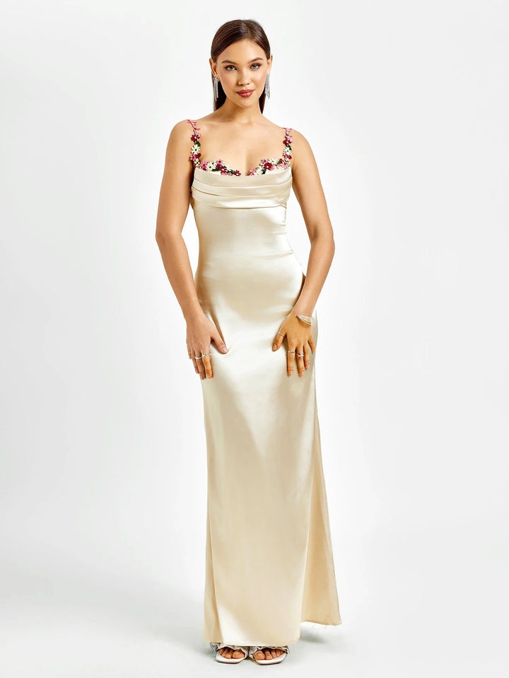 "Sleeveless black maxi dress with intricate embellishments, perfect for a night out or special occasion."