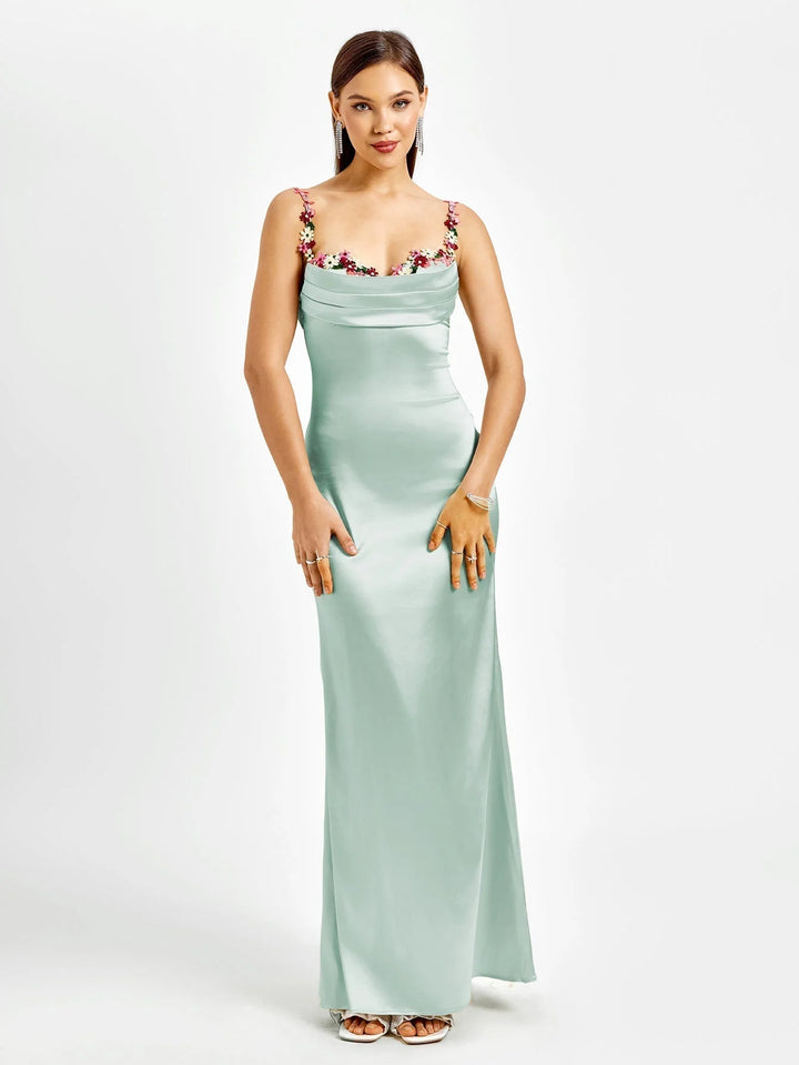 Sleeveless black maxi dress with intricate embellishments, form-fitting silhouette, perfect for special occasions or elegant…