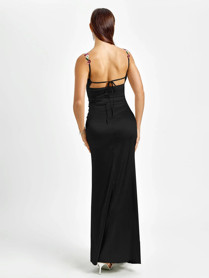 "Sleeveless maxi dress with embellishments in soft blue, perfect for special occasions. V-neck and fitted silhouette add…