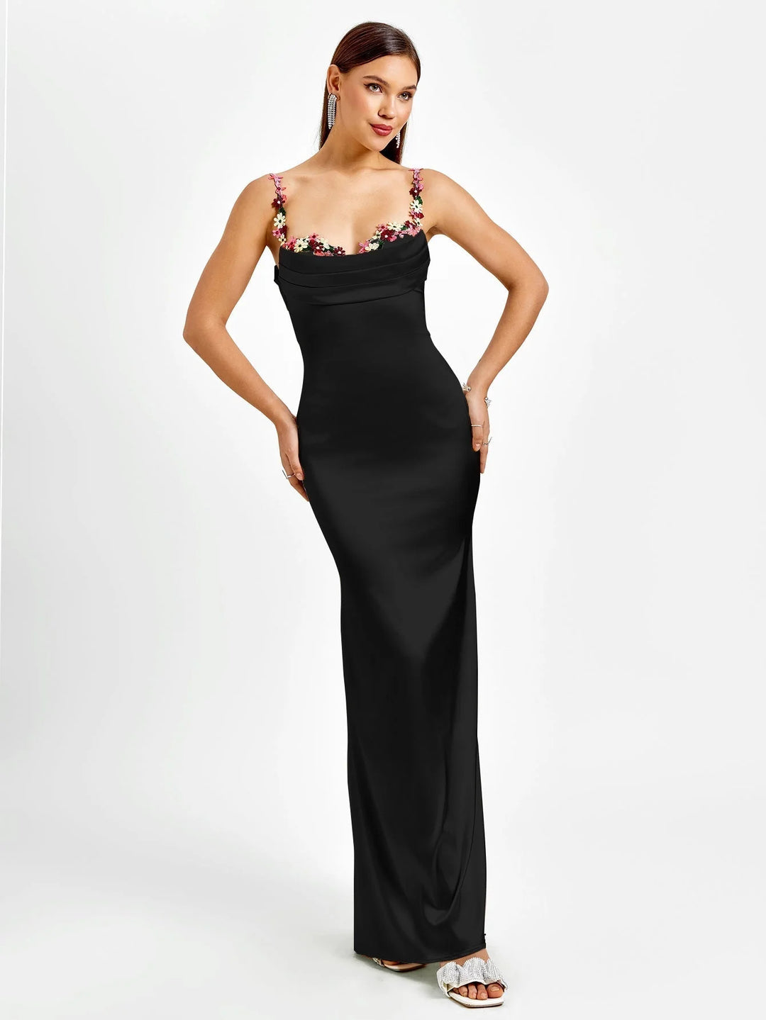"Sleeveless black maxi dress with intricate embellishments, showcasing a fitted silhouette and elegant design by Kenleigh."