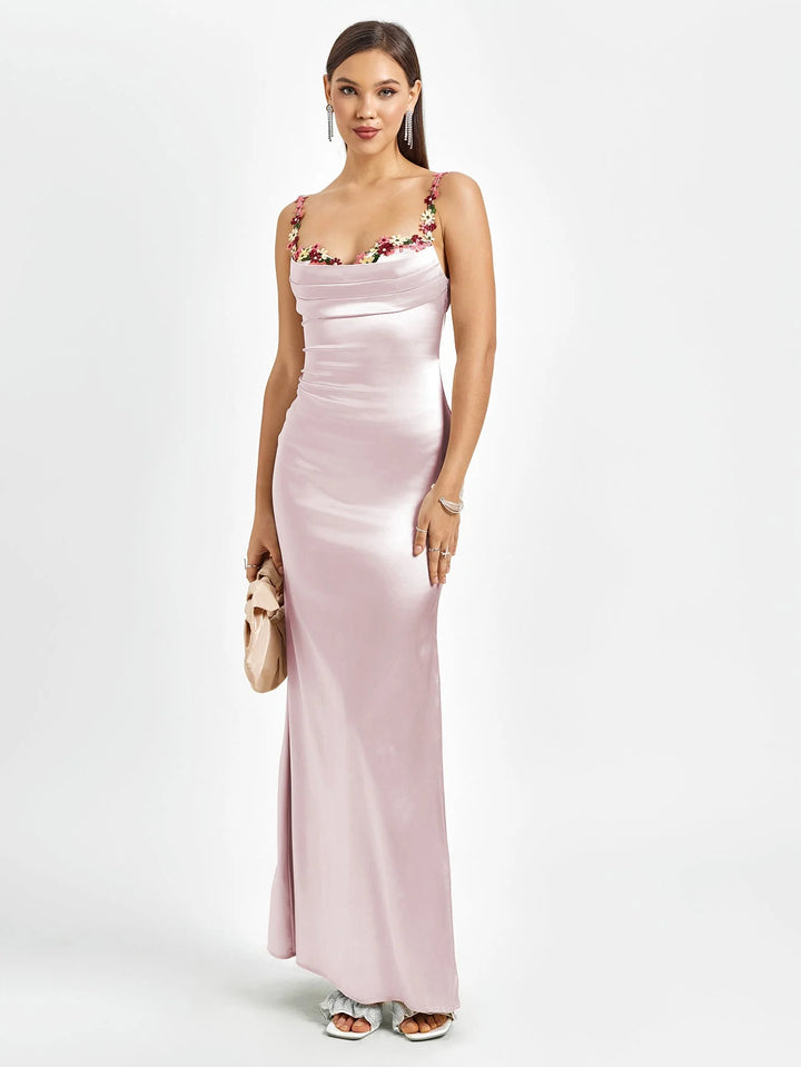 "Sleeveless fitted pink maxi dress with embellishments, perfect for a special occasion. Made with high-quality fabric."