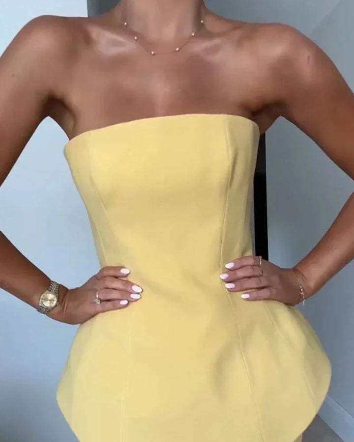 Yellow strapless peplum top with ribbed skirt in soft textured fabric.