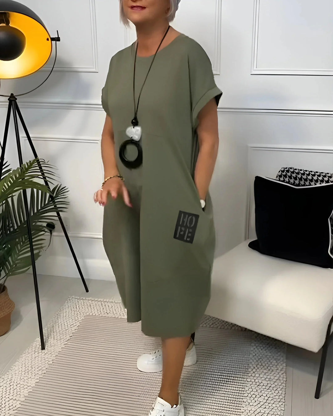 "Black sleeveless midi dress with pleated detailing and stretchy fabric for a comfortable yet chic look by Kassandra"