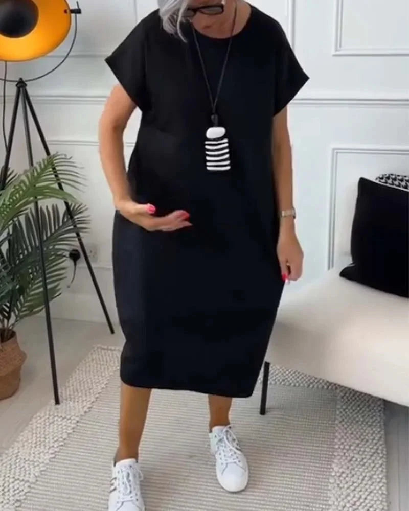 "Black knee-length dress with v-neck and loose silhouette, made from soft cotton blend for a comfortable and stylish fit."