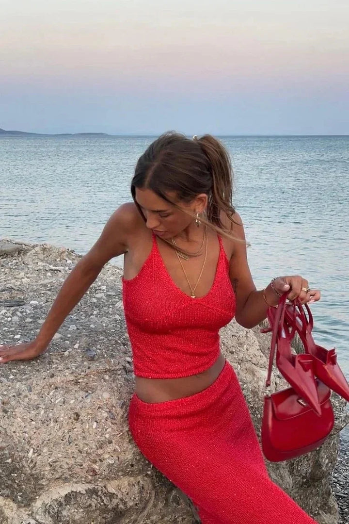 Red sparkly top and pants set by Crystal, shimmering sequins detailing on a cozy knit fabric.