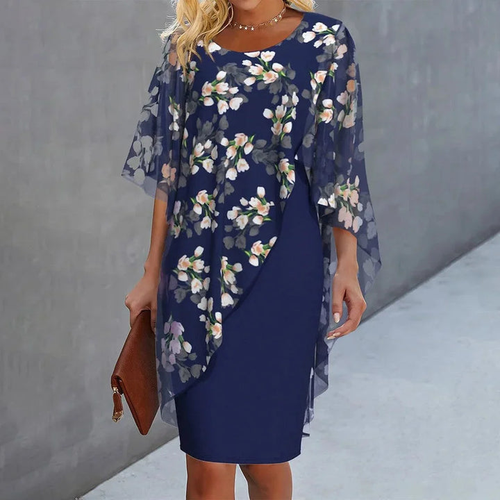Blue shift dress with sheer floral overlay, perfect for any occasion.