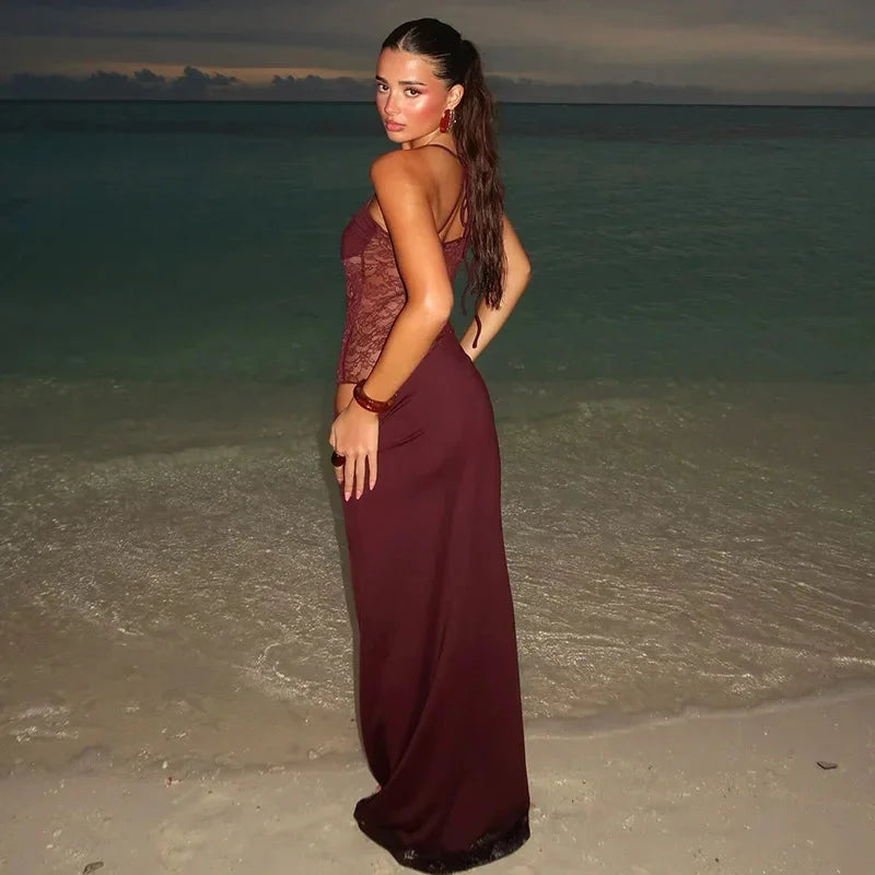 Black sleeveless evening maxi dress with intricate lace detailing, perfect for special occasions.