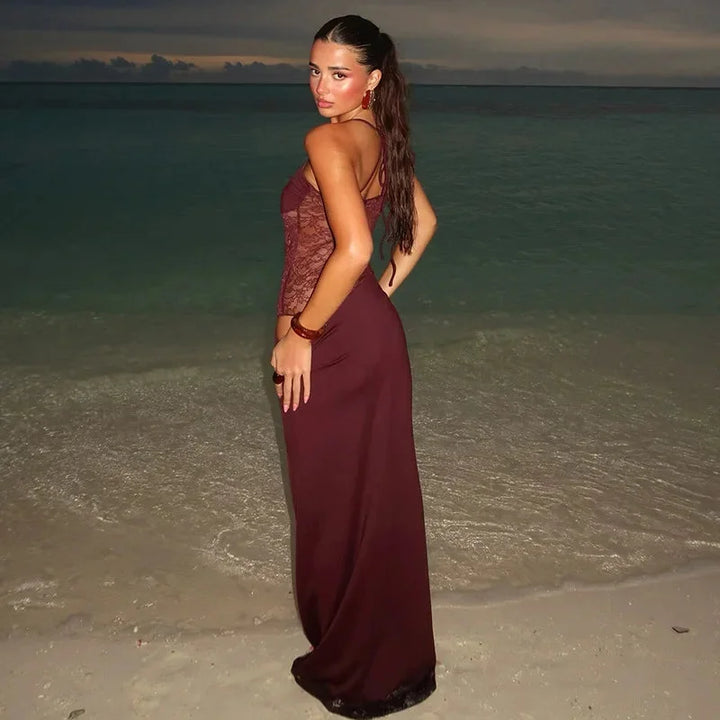 Black sleeveless evening maxi dress with intricate lace detailing, perfect for special occasions.