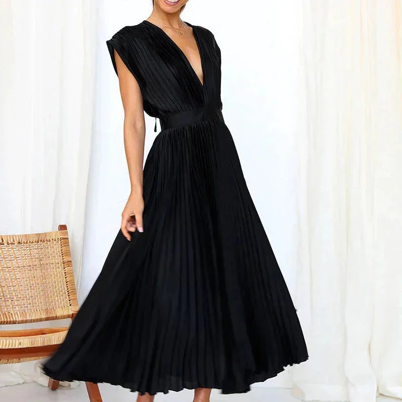 "Zury pleated dress with deep V-neckline in navy, showcasing a modern silhouette and elegant pleats."