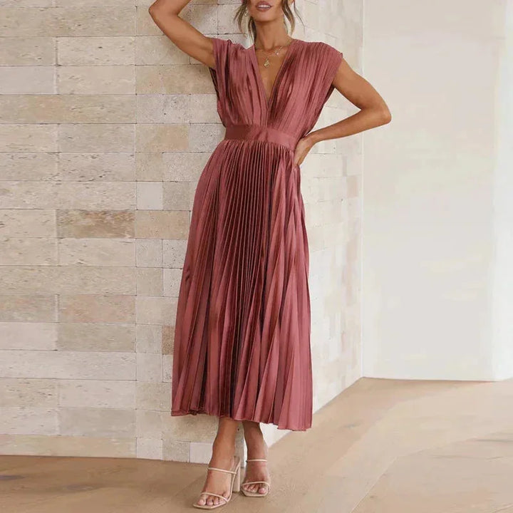 Red pleated dress with deep V-neckline 'Zury' crafted in soft chiffon fabric. Elegant and chic design for a sophisticated…