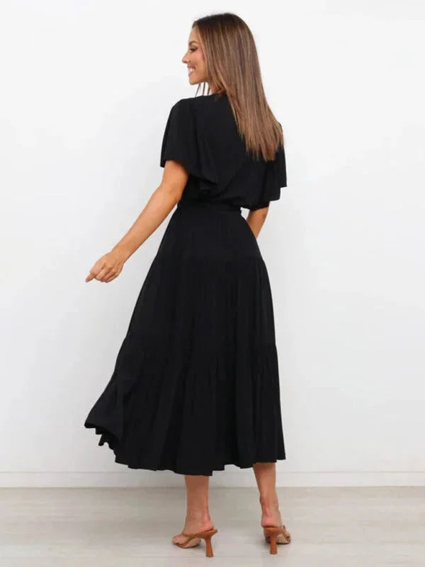 "Kaleigha tiered midi dress in navy blue with a belted waist, perfect for a casual yet stylish look."