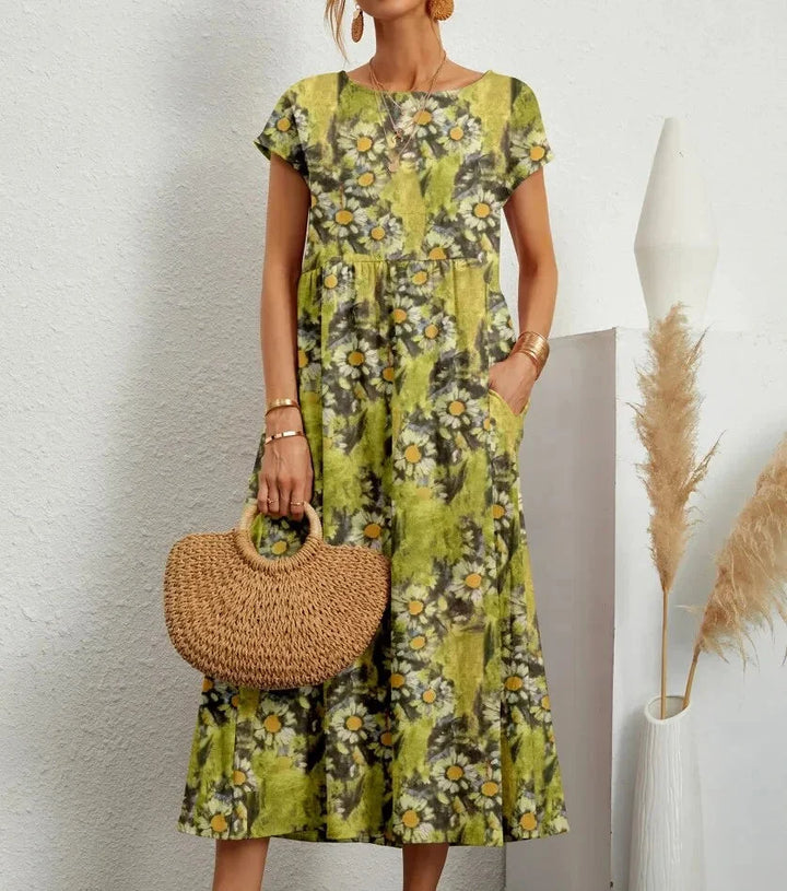 Light green cotton midi dress with intricate floral print design in Yamilet collection. Perfect for a chic and effortless…