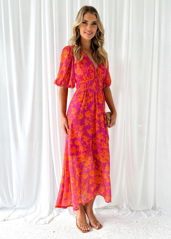 Bright pink floral maxi dress with a whimsical Manal pattern, perfect for summer events. Made from lightweight, breathable…