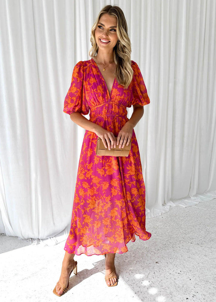 "Bright pink floral maxi dress featuring a whimsical Manal print, perfect for a summery and feminine look."