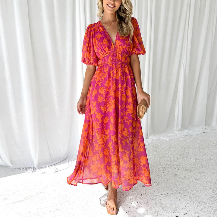 Bright pink floral maxi dress featuring a delicate Manal pattern, ideal for a casual or formal wear with a flowy silhouette.