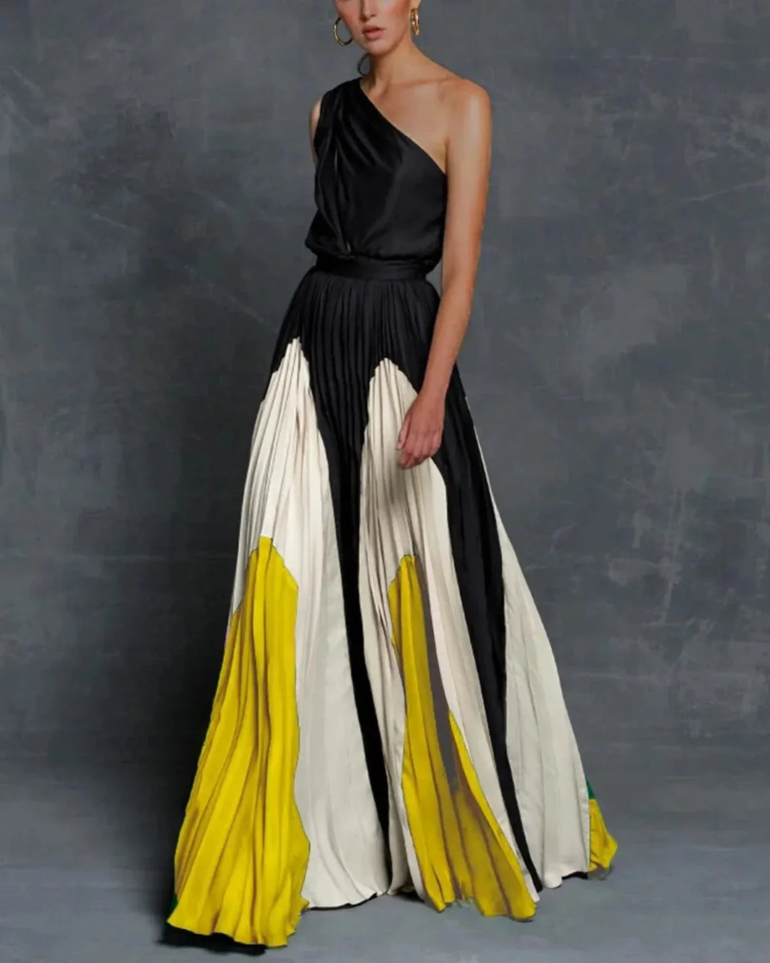 Yellow one-shoulder pleated maxi dress by Cheyenne, showcasing a graceful design with a single shoulder strap and pleats.