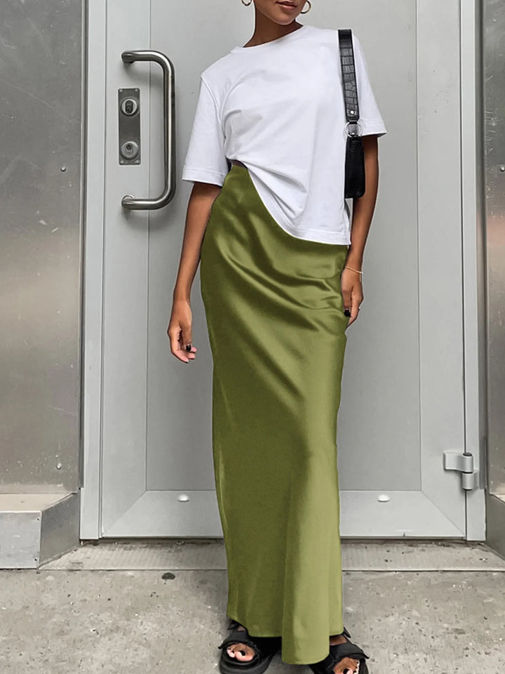 Green satin maxi skirt, flowing design.