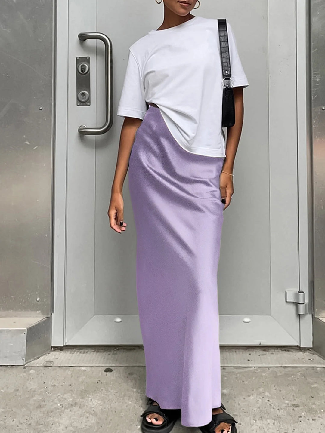 Purple satin maxi skirt featuring a flowy design.