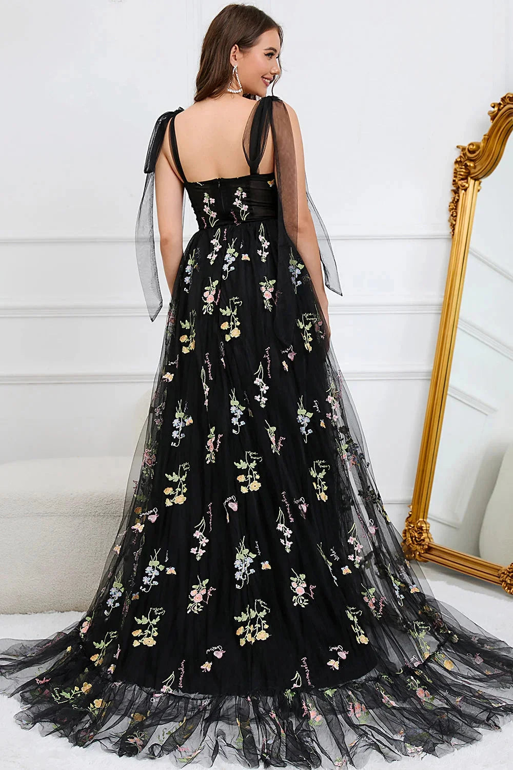 White Bianca dress with intricate embroidery on tulle fabric, featuring a sheer overlay for a romantic and elegant look.