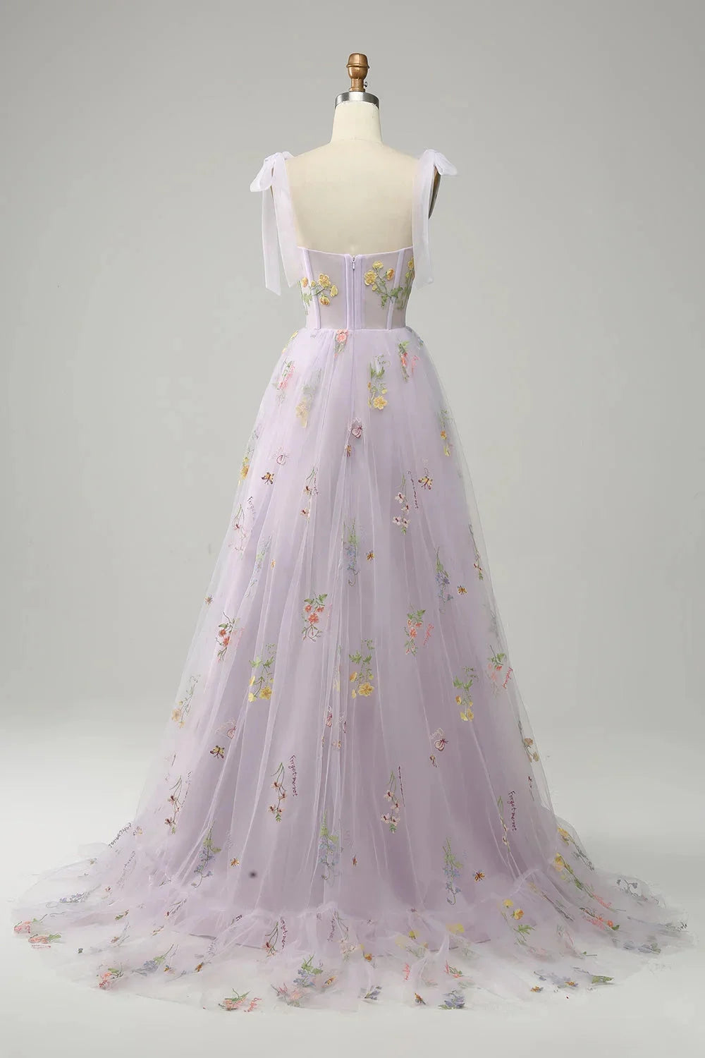 "Bianca tulle dress with sheer overlay, featuring elegant embroidery detail on a lightweight and flowy fabric."