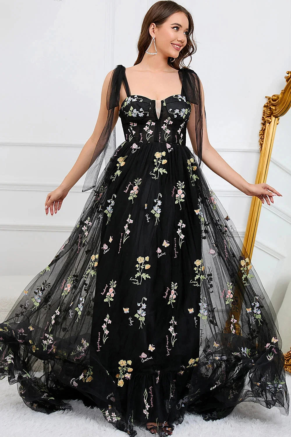 Black tulle dress with intricate embroidery and sheer overlay, exuding elegance and sophistication.