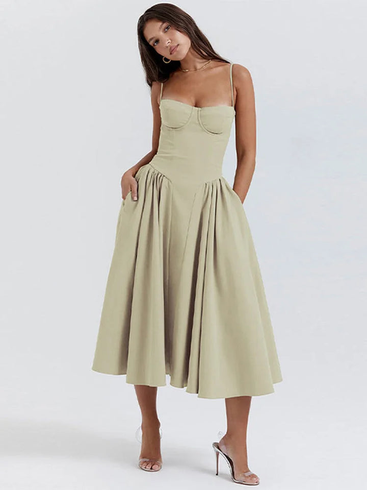 Green slimming bodice sundress with flared skirt by Zamya, made of stretchy fabric. Perfect for casual or special occasions.