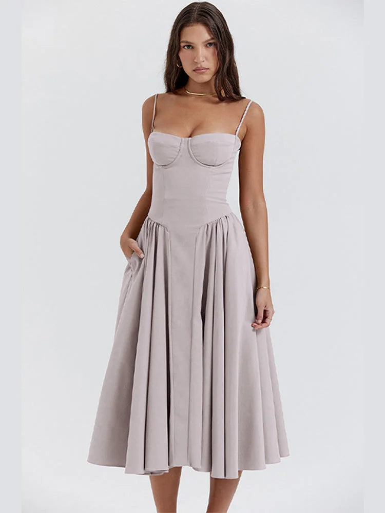 Light grey slimming bodice sundress with flared skirt by Zamya. Features soft cotton fabric and a flattering silhouette for…