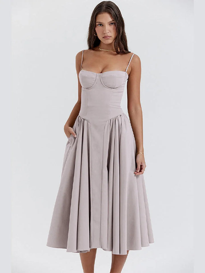 Light grey slimming bodice sundress with flared skirt by Zamya. Features soft cotton fabric and a flattering silhouette for…