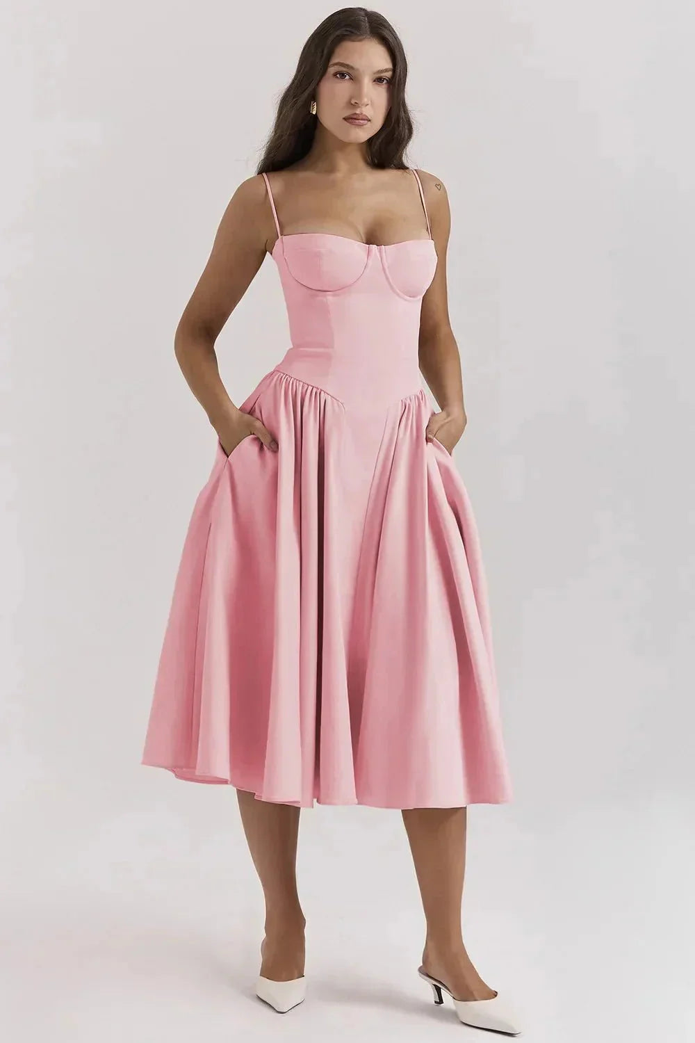 Pink slimming bodice sundress with flared skirt by Zamya. Features breathable fabric and flattering silhouette for a chic…